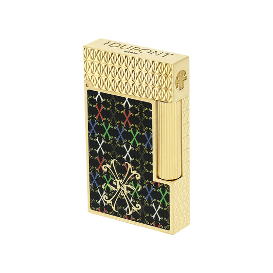 A gold-tone lighter with a textured top and side, featuring a black front panel decorated with a colorful repeating X pattern and a gold monogram logo. The brand name 'DUPONT' is engraved on the top.